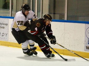 Sarnia Legionnaires defenseman Matt Cimetta protects the puck from LaSalle Vipers forward Kyle Quick Oct. 26 at the Vollmer Centre. (Photo by: Joel Boyce)