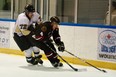 Sarnia Legionnaires defenseman Matt Cimetta protects the puck from LaSalle Vipers forward Kyle Quick Oct. 26 at the Vollmer Centre. (Photo by: Joel Boyce)