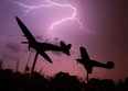 Lightning bursts across the sky as the Spitfire and Hurricane planes are silhouetted at Jackson Park in Windsor, Ont. during summer storms. (JASON KRYK/ The Windsor Star)