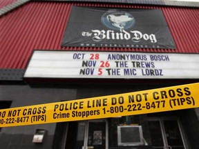 Police tape surrounds the front of The Blind Dog bar on Ouellette Avenue on Wednesday, Nov. 9, 2011, in Windsor, Ont. A fire was reported inside the club around 1 a.m.