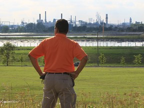 Windsor resident and hum believer Gary Grosse eyes the industrialized landscape of the west end in this file photo.