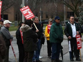 A small group of demonstrators listen to Andy Schmidt (not pictured), co-chair of the National Pension Reform Committee, talk about reforming Canadian pensions, outside of City Hall in downtown Windsor, Sunday, Dec. 4, 2011.  (Photo By: Dax Melmer)