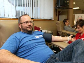 First time donor Wade Huber waits patiently while donating blood at the Canadian Blood Services in Windsor on Saturday, Dec. 24, 2011. Huber was one of many donors who decided to give blood on Christmas Eve. (DYLAN KRISTY/The Windsor Star).