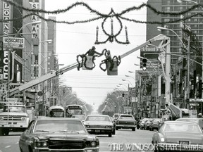 NOV.14/1974- Workers began stringing Christmas decorations on Ouellette Ave. and within hours Mother nature got into the festive spirit providing the first snowfall of 2.2 inches of snow. (The Windsor Star-Cec Southward)