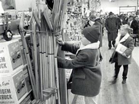 -Dec.17/1968-One of the big attractions for boys is sports equipment and nine year old Tom Hayes is no different. Tm looks over the hockey sticks with hope that on Christmas morning there will be one waiting for him. (The Windsor Star-Bill Bishop)