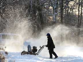 A LaSalle resident uses a snow blower in this December 2010 file photo.