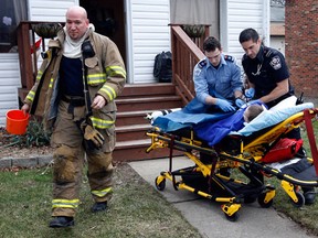Essex-Windsor EMS paramedic prepare to transport a five-year-old burn victim to Windsor Regiona Hospital's Met campus from a residence at 4567 Wyandotte Street East Tuesday January 24, 2012. Windsor firefighters quickly arrived on the scene and initially assisted the young victim. (NICK BRANCACCIO/The Windsor Star)