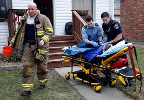 Essex-Windsor EMS paramedic prepare to transport a five-year-old burn victim to Windsor Regiona Hospital's Met campus from a residence at 4567 Wyandotte Street East Tuesday January 24, 2012. Windsor firefighters quickly arrived on the scene and initially assisted the young victim. (NICK BRANCACCIO/The Windsor Star)