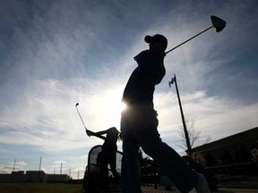Jamie Martinello, right, and Brianne Macpherson, 14, take advantage of the unseasonably warm weather to practice their swings at Tecumseh Golf, Sunday, Jan. 8, 2012. (DAX MELMER/The Windsor Star)