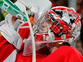 Jimmy Howard #35 of the Detroit Red Wings takes a drink while playing the Phoenix Coyotes at Joe Louis Arena on January 12, 2011 in Detroit, Michigan. Detroit won the game 3-2 in a shootout. (Photo by Gregory Shamus/Getty Images)