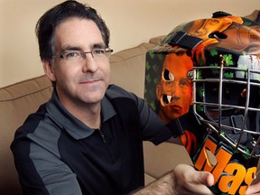 MP Brian Masse displays his custom designed goalie mask Thursday, Jan. 26, 2012, at his Windsor, Ont. home. The head gear features a number of elements including former NDP leaders Tommy Douglas and Jack Layton and Windsor's auto history.