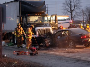 Tecumseh firefighters mop up after a head-on collision on County Road 42 on Jan. 24, 2012. (Photo By: Dylan Kristy)