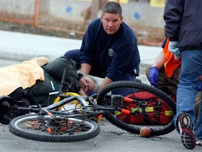 WINDSOR firefighters assist a man who was hit while riding his bicycle on the corner of Goyeau Street and Elliott Street Thursday January 5, 2012. Essex-Windsor EMS paramedics transported the man to Hotel-Dieu Grace Hospital. (NICK BRANCACCIO/The Windsor Star)