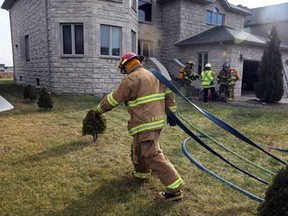Lakeshore firefighters respond to a fire call at 376 Pinehurst Drive near East Puce Road Monday January 9, 2012. OPP were at the scene investigating the incident. (NICK BRANCACCIO/The Windsor Star)
