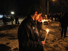 Family and friends of Sharri Lluhani gathered Monday, Jan. 30, 2012, for a vigil to remember the 24-year-old who was killed Sunday morning in a crash on Riverside Dr. E. Close friend Leke Gjocaj breaks down during the vigil. (Dan Janisse/The Windsor Star)