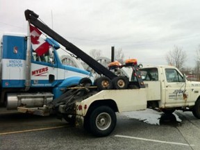 A Canadian flag hangs from the back of a Sandwich West tow truck. (Photo By: Dylan Kristy)