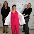 Hotel-Dieu Grace Hospital worker Carla Soulliere, centre, demonstrates a WeightWatchers "reveal" following an award presentation by WeightWatchers Andrea Bradford-Lambert, right, to Toni Janik, left, director of health science library at Hotel-Dieu Grace Hospital January 19, 2012. (Photo By: Nick Brancaccio)