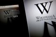 The Wikipedia website is arranged on a laptop and tablet computer in Beijing, China, on Wednesday, Jan. 18, 2012. Wikipedia, the online encyclopedia where users contribute entries, shut the English version of its website for 24 hours to protest Hollywood-backed anti-piracy measures in the U.S. Congress. Photographer: Nelson Ching/Bloomberg