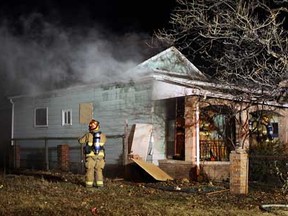 Firefighters battle a blaze in the 200 block of Aylmer Avenue in Windsor on Tuesday , January 10, 2012. The fire broke out shortly before 10 p.m. and was quickly extinguished by firefighters. Firefighters were called to same home within the last two weeks for another similar blaze. (TYLER BROWNBRIDGE / The Windsor Star)