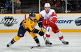 Ryan Ellis #49 of the Nashville Predators skates against Justin Abdelkader #8 of the Detroit Red Wings at the Bridgestone Arena on December 26, 2011 in Nashville, Tennessee. (Photo by Frederick Breedon/Getty Images)