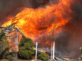 A home in the 1000 block of Esdras Place is engulfed in flames Mar. 24, 2011, in Windsor, Ont. (Photo By: Dan Janisse)