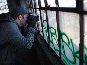 Dennis Maitland, a Detroit-based photographer from Romeo, MI, takes photos while exploring the Detroit Harbor Terminal, also known as the Boblo Dock Building, south-east of downtown Detroit, MI, Monday, Feb. 20, 2012. Maitland is having a gallery showing of his work at Phog Lounge in downtown Windsor through the month of February. (DAX MELMER / The Windsor Star)