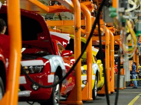 Assembly line workers build the Chevrolet Camaro at the General Motors (GM) plant in Oshawa, Ontario Friday, December 16, 2011. (Tyler Anderson/National Post)