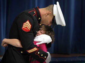 Mike Desjardins, a Sgt. In U. S. Marine Corp reserves hugs his son Justin Desjardins, age 11, as the two reunite at St. John the Baptist Catholic Elementary School in Belle River, Ontario on February 9, 2012. Mike Desjardins surprised his son after returning from Afghanistan following a tour of duty. (JASON KRYK/ The Windsor Star)