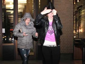 Two females are photographed leaving the Superior Court of Justice after hearing the verdict of Timothy Carter and Donald Dodd who were both found guilty of second-degree murder in the deaths of Vaios (Zorba) Koukousoulas, 63, and Panayotis (Peter) Kambas, 53 late Saturday, Feb. 18, 2012. The two females met up with a group of people outside the courtroom who were crying and yelling out profanities, saying they disagreed with the verdict.