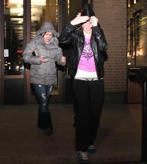 Two females are photographed leaving the Superior Court of Justice after hearing the verdict of Timothy Carter and Donald Dodd who were both found guilty of second-degree murder in the deaths of Vaios (Zorba) Koukousoulas, 63, and Panayotis (Peter) Kambas, 53 late Saturday, Feb. 18, 2012. The two females met up with a group of people outside the courtroom who were crying and yelling out profanities, saying they disagreed with the verdict.