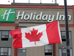 The Canadian flag remains at half staff at the Holiday Inn on Huron Church road in Windsor, Ontario on February 27, 2012. The engineers who died in the Via Rail crash near Burlington, Ontario, often stay at the Windsor hotel. Management at the hotel lowered the flags to pay respects to the deceased Via Rail employees. (Jason Kryk/The Windsor Star)