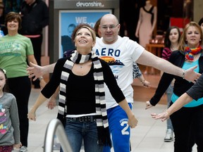Brianna Bonnici, left, Brandy Stojanovski, front centre, and Eric Bonnici, behind centre, were part of a flash mob promoting health and fitness was led by fitness instructor Krista Kersey (not shown) and others at Devonshire Mall, February 29, 2012. (NICK BRANCACCIO/The Windsor Star)