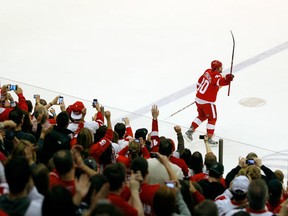 Henrik Zetterberg #40 of the Detroit Red Wings salutes fans as the first star of the game after the Red Wings NHL record breaking 21st consecutive home victory defeating the Dallas Stars 3-1 at Joe Louis Arena on February 14, 2012 in Detroit, Michigan. (Photo by Gregory Shamus/Getty Images)