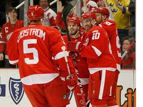 Detroit's Henrik Zetterberg celebrates his goal with Johan Franzen, Ian White, centre, and Nicklas Lidstrom, left, against the Dallas Stars at Joe Louis Arena February 14, 2012 in Detroit. The Wings won 3-1 to set an NHL record of 21 straight home victories.  (Gregory Shamus, Getty Images)