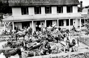 Petite Cote,(Lasalle) Ont. 1912-Empty wagons and weary faces fill Front St. in Petite Cote as residents enjoy a cold beer at the close of a market day. (The Windsor Star-FILE)