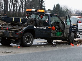 OPP officers investigate at the scene of a fatal motor vehicle accident on highway 3 near Windsor on Tuesday, January 17, 2012. A tow truck driver was changing the tire on a vehicle when he was struck and killed by a passing Mercedes Benz. (Tyler Brownbridge/The Windsor Star)