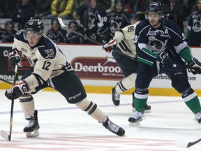 Windsor's Ben Johnson, L, brings the puck up the ice in the first period as the Windsor Spitfires host the Plymouth Whalers at the WFCU Centre, Saturday, Dec. 31, 2011. (DAX MELMER / The Windsor Star)