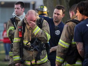 Windsor firefighter Andre Gervais wipes sweat and dirt from his forehead after exiting a fire which caused $100,000 damage to a home at 1845 Gladstone Ave. Wednesday March 14, 2012. Nobody was home at the time of the fire.