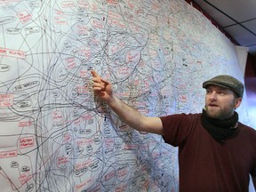 Tom Lucier has been working on an art project which archives local musicians and connects them to the bands they've played in. This project has created the rock wall, a 15' by 10' tangle. Lucier is shown with the piece Wednesday, Feb. 29, 2012, at the Phog Lounge in Windsor, Ont. (DAN JANISSE/The Windsor Star)