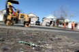 LONDON, ONT. -- In this file photo, shattered glass and remnants of St. Patrick's Day celebrations scatter Fleming Drive in London, Ont. where a mob of 1,000 flipped a news truck and caused about $100,000 of damage. Municipal crews had to repair a section of the residential of the road which had been scarred by the fire and had shards of debris melted in the pavement. (DYLAN KRISTY/The Windsor Star)