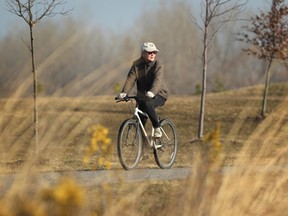In this file photo, cyclist Paulette Coady rides the Ganatchio Trail on Mar. 13, 2012. Many consider Ontario's offer of $7,500 for Windsor's cycling routes - compared to a $5-million local budget set for cycling paths - a token effort by a government preparing for an election. (Dax Melmer / The Windsor Star)