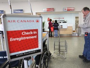 A traveller checks in for a Toronto flight at Windsor's airport on Mar. 23, 2012.