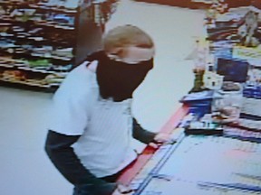 A surveillance camera image of a man who robbed a convenience store on Queen Street South in Tilbury, Ont. around 10:30 p.m. on Mar. 29, 2012.