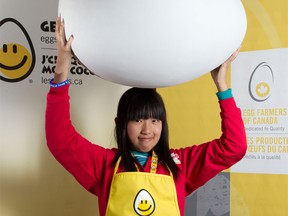 Zhongtian Wang of Windsor poses with a giant egg prop in Toronto, Ont. on Mar. 27, 2012.