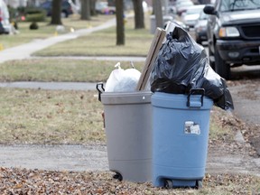 Trash waits for collection by a curb in a Windsor neighbourhood in this February 2012 file photo.