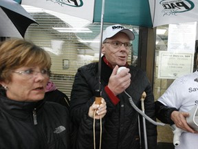 Harness racing legend Bob McIntosh (centre) joins a protest by Windsor Raceway supporters at the Windsor offices of Ontario Finance Minister Dwight Duncan on Mar. 30, 2012.