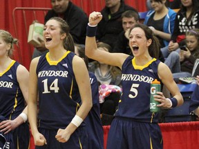 Tessa Kreiger (L) and Bojana Kovacevic of the University of Windsor Lancers women's basketball team celebrate their victory at the CIS Final 8 championships in Calgary, Alberta on March 19, 2012.