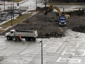 Workers break up the parking lot at Bruce Avenue and Chatham Street West - the location of Windsor's future Family Aquatic Complex. Photographed on March 8, 2012.