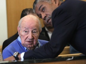 Manuel 'Matty' Moroun (L), the billionaire owner of the Ambassador Bridge, consults with his lawyer Godfrey Dillard at a hearing in the Wayne County Circuit Court in Detroit, MI on Mar. 22, 2012.