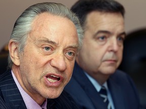 Paul Godfrey (L) chair of the board of directors of the Ontario Lottery and Gaming Corporation (OLG) and Ontario finance minister Dwight Duncan address media in Windsor on Mar. 14, 2012.